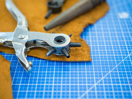 Leather crafting tools still life in masters workshop.