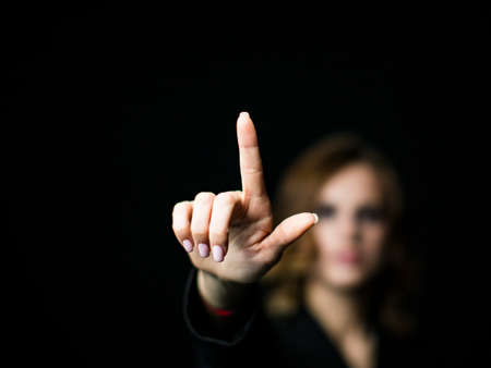 Businesswoman working with modern virtual technologies hands touching the screenの写真素材