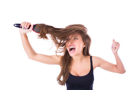 Young beautiful girl having problems while hair. Isolated studio shotの写真素材