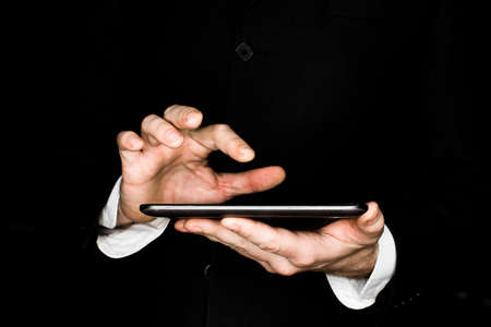 hands of a businessman work with a tablet computer.