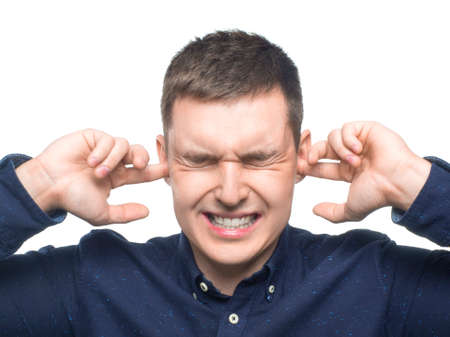 Man holding hands to ears. Portrait of man holding hands to ears covering to shut out noise over...