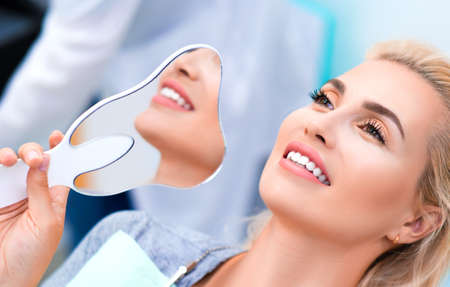 Close up photo of a smiling woman in dental clinicの写真素材