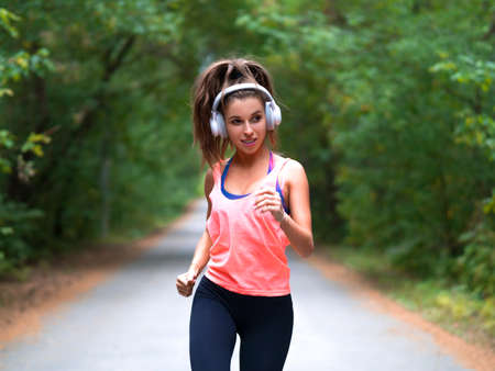 Woman running in a forest. Fitness healthy lifestyle concept.の写真素材