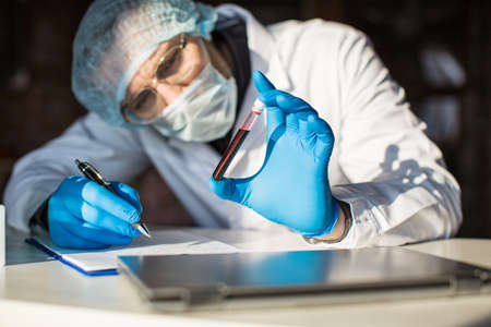 Close up view of blood sample in researcers hands.