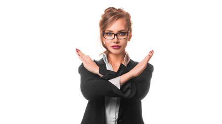 Serious business woman shows a stop sign crossed hands.