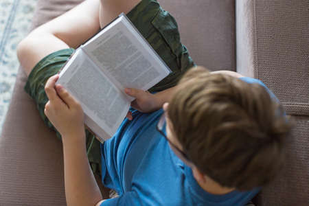 Top view of a reading teenager boy.の写真素材
