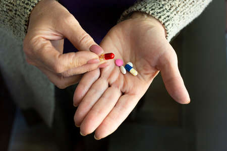 Drugs in old woman's hands. Health care and medicine concept.
