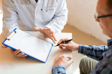 Patient and doctor. Signing medical insurance. Healthcare concept.の写真素材