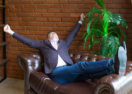 Businessman having rest after strong, but successful negotiations and contracting.の写真素材