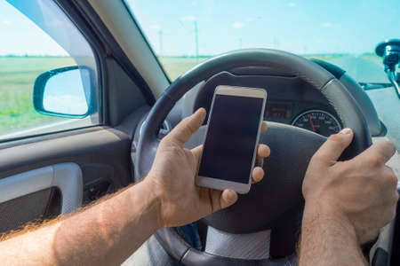 Man using cellphone while driving.