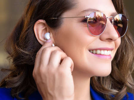 Happy smiling woman in sunglasses win headset.