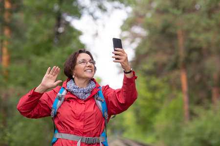 Senior hiker woman having a video callの写真素材