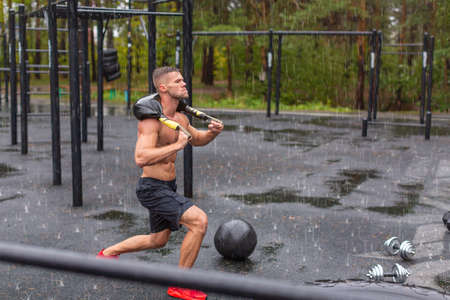 Exercise lunges outdoors on a rainy day.の写真素材
