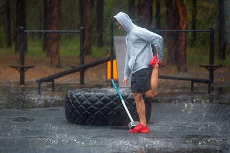 A man stretches his legs before a hard workout.
