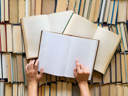 Childrens hands with books. The child is studying science.