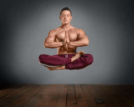 Levitation. Healthy strong man in lotus prayer position.の写真素材