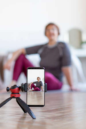 Active seniors concept. Senior woman preparing to exercising online.の写真素材