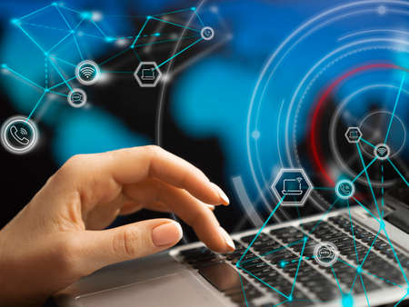 Close-up hands with laptop keyboard. Double exposure - icons, connections and schematic...