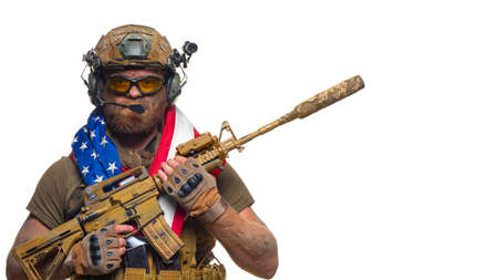 American soldier stands with a flag on his shoulders over white background - concept of the day of...