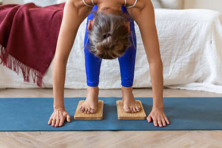 Cropped image - middle-aged woman standing on a board with sharp nails. Sadhus boards yoga practice.の写真素材