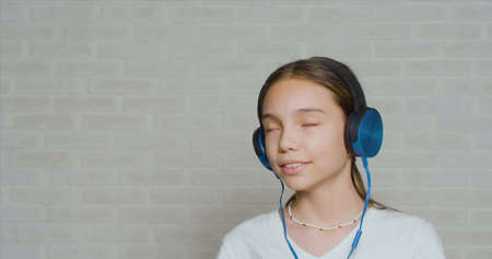 Teenage girl in a headphones listening to the calm music.の写真素材