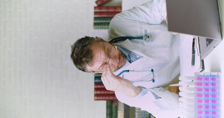 Vertical video of a doctor working long hours.の写真素材
