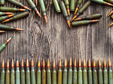 Weapon ammo on a dark wooden background.の写真素材