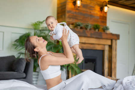 Mother and her baby girl having playing and having fun.の写真素材