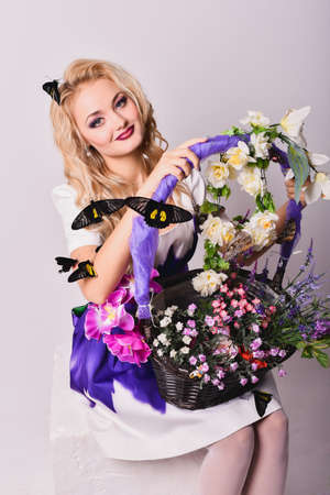 Attractive blonde girl with exotic tropical butterflies in studioの写真素材