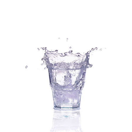 Fresh water splash in a glass isolated on white background
