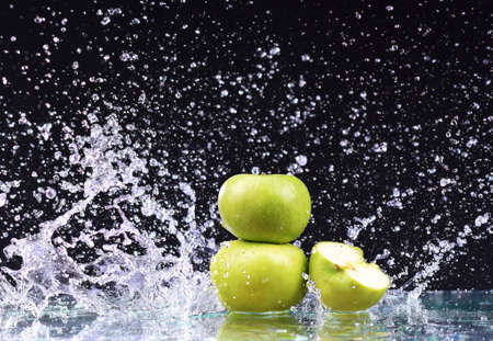 Macro three green apple in water drop streamの写真素材