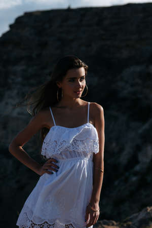 Girl in a colorful dress standing in the background of the amazing Blacksea coastの写真素材