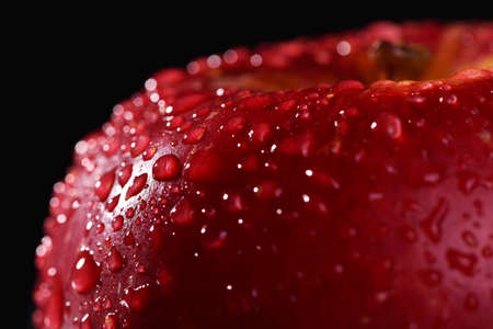Red apple on dark background. Macro water dropsの写真素材