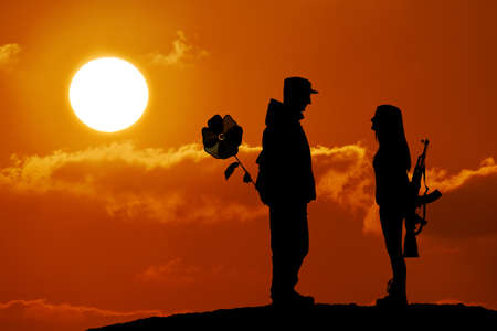 Silhouette of peace and love versus war and anger. No war, soldier and girl, weapon and flower toy, peace in world, sunset, landscapeの写真素材