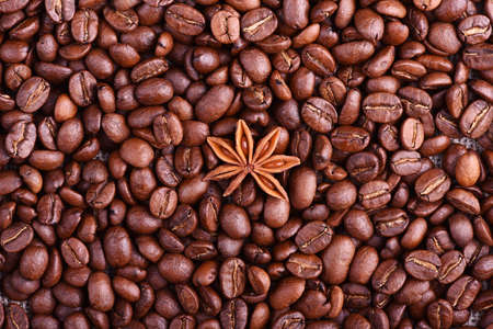 Brown coffee, cinnamon and star anise on the tableの写真素材