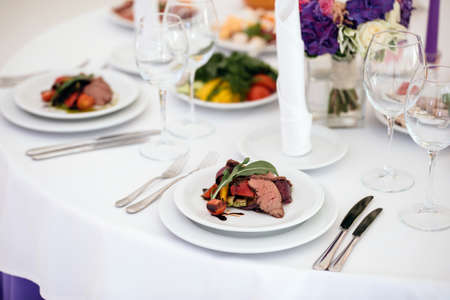 Banquet in restaurant. Table setting, fresh food.の写真素材