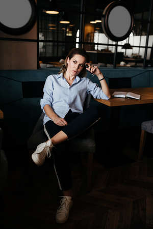 Pretty woman thinking and make records in daily planner. Casual style clothesの写真素材