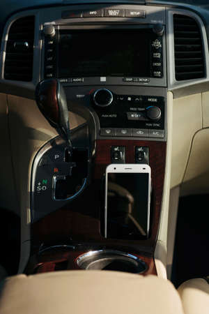 white smartphone, phone in luxury car