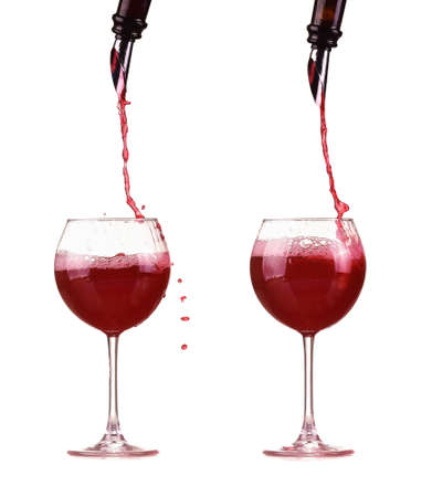 red wine pouring from a bottle into a glass through a dispenserの写真素材