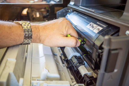 a man changes a cartridge on a laser printer. copyspace.の写真素材