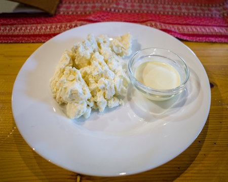 a plate with cottage cheese and sour creamの写真素材