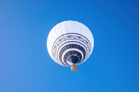 a white balloon against the background of a frosty blue clear skyの写真素材