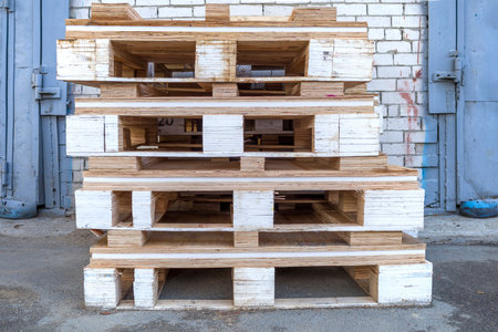 Stack of wooden pallets for industrial and transport applications near warehousesの写真素材