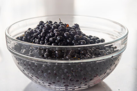 blueberries in a large glass bowl on a white table background. close up.の写真素材