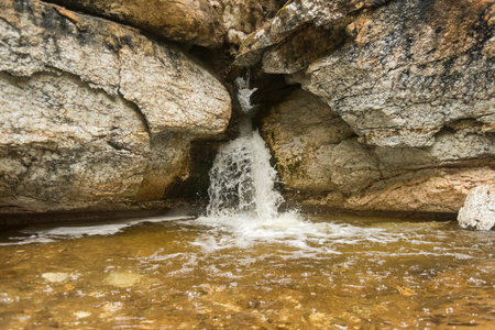 a small waterfall among rocks in a wild forest. Arkhangelsk region Pinezhsky district Golubino National Parkの写真素材