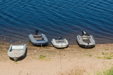 modern rubber fishing motor boats on the sandy bank of the river.fishing and tourism. natural lightの写真素材