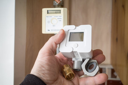 a man holds a new gas meter in his hands. replacing the old counter. close-upの写真素材