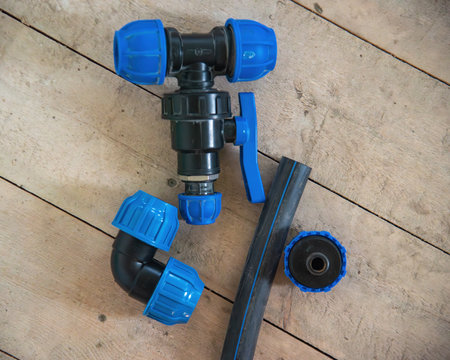 Connecting HDPE plastic water pipes on wooden floor