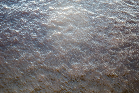 top view of the surface of the river illuminated by the sun with small waves