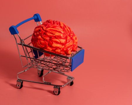 an iron shopping cart on wheels with a brain. the concept of discounts and consumption. pink...